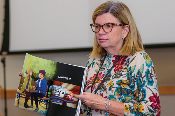 anne brown holding "my life is worth living" book