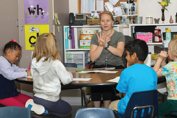 Teacher at table with children